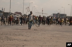 FILE - Angry residents take to the streets to protest violence against civilians in Goma, Congo, Aug. 2, 2013.