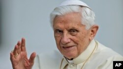 Pope Benedict XVI delivers his blessing as he arrives for a weekly general audience in St. Peter's Square at the Vatican, Oct. 3, 2012. 