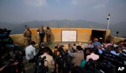 Pakistan's army spokesman Lt Gen. Asim Bajwa, second from right, with area commanders briefs to journalits at a forward area Bagsar post on the Line of Control (LOC), in Bhimber, some 166 kilometers (103 miles) from Islamabad, Oct. 1, 2016.