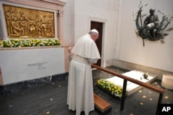 Pope Francis prays at the grave site of Jacinta and Francisco Marto at the Sanctuary of Our Lady of Fatima, May 13, 2017, in Fatima, Portugal.