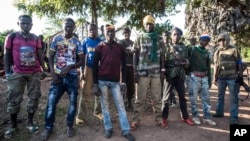 FILE - Anti-balaka fighters stand for a photo in Boda, Central African Republic, Aug. 2014.