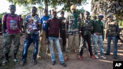 FILE - 'Anti-Balaka' fighters stand for a photo in Boda, Central African Republic, Aug. 28, 2014.