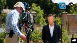 Tom Newton Dunn, Political Editor of The Sun Newspaper (R) is seen speaking to Fox Television News network at Chequers, in Buckinghamshire, England, July 13, 2018.