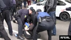Assailants attacked gay and transgender rights activists and torched a rainbow flag at a small rally in the Ukrainian city of Kharkiv.