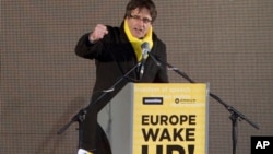 Ousted Catalan leader Carles Puigdemont speaks to pro-Catalan supporters during a demonstration near the EU quarter in Brussels on Thursday, Dec. 7, 2017.