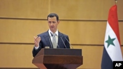 Syria's President Bashar al-Assad speaks at Damascus University in Syria, January 10, 2012.