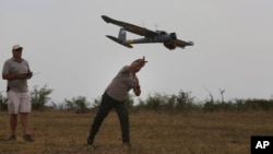 FILE - In this file photo taken Monday, Feb. 15, 2016, a drone is launched in the Hluhluwe-iMfolozi Game Reserve in the KwaZulu Natal province. 