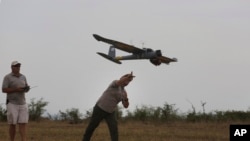 FILE - A drone is launched on a game reserve in South Africa, Feb. 15, 2016.