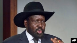 South Sudan's President Salva Kiir, shown here after meeting with Sudan's President Omar al-Bashir in Juba in January, has restored 6 government ministries. 