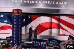 Republican presidential nominee Donald Trump joins Mike Pence, who had just accepted the vice presidential nomination, on stage in Cleveland, July 20, 2016. Trump will accept the party's nomination on Thursday.