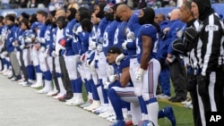 FILE - New York Giants defensive end Olivier Vernon kneels as the Giants stand for the national anthem before an NFL football game against the Washington Redskins Dec. 31, 2017, in East Rutherford, N.J. 