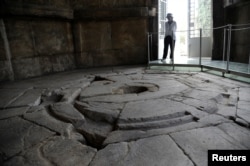 A guard is seen inside the Tower of the Winds, open to the public for the first time in more than 200 years after being restored, in the Roman Agora, in Plaka, central Athens, Greece, Aug. 23, 2016.