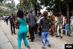 Young people dance on the grounds of the ruling PPRD party campaign office. (C. Oduah/VOA)