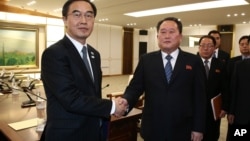 South Korean Unification Minister Cho Myoung-gyon, left, shakes hands with the head of North Korean delegation Ri Son Gwon after their meeting at the Panmunjom in the Demilitarized Zone in Paju, South Korea, Jan. 9, 2018.