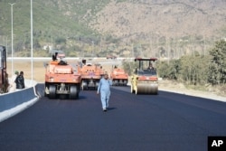 FILE - Work in progress at the site of Pakistan China Silk Road in Haripur, Pakistan, Dec. 22, 2017.