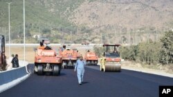 FILE - Work in progress at the site of Pakistan China Silk Road in Haripur, Pakistan, Dec. 22, 2017. 