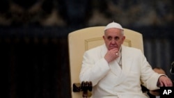 Pope Francis listens to his speech being translated in several languages, during his weekly general audience in St. Peter's Square at the Vatican, Feb. 5, 2014. 
