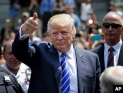 Donald Trump gives a thumbs-up as he leaves for lunch after being summoned for jury duty in New York, Aug. 17, 2015.
