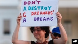 Trump ImmigrationJulia Paley, of Arlington, Va., with the DMV Sanctuary Congregation Network, holds up a sign during a rally supporting Deferred Action for Childhood Arrivals, or DACA, outside the White House in Washington, Sept. 4, 2017. 