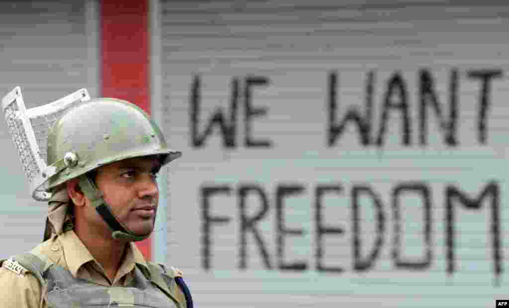 An Indian paramilitary trooper stands guard during curfew in downtown Srinagar. Indian-administered Kashmir has been in the grip of almost daily anti-India protests and rolling curfews.