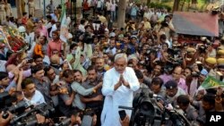 Bihar Chief Minister Nitish Kumar, center, greets supporters after victory in Bihar state elections Nov. 8, 2015. (AP Photo/Aftab Alam Siddiqui)