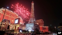 FILE - Fireworks explode at a replica of the Eiffel Tower of Parisian Macao during an opening ceremony in Macau, China, Sept. 13, 2016. The southern Chinese casino gambling powerhouse of Macau is getting a French twist, thanks to U.S. billionaire Sheldon 