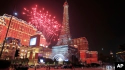 FILE - Fireworks explode at a replica of the Eiffel Tower of Parisian Macao during an opening ceremony in Macau, China, Sept. 13, 2016. The southern Chinese casino gambling powerhouse of Macau is getting a French twist, thanks to U.S. billionaire Sheldon Adelson. 