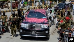 A vehicle carrying Syed Salahuddin, the top leader of the Hizbul Mujahideen, is escorted by his supporters, arrives for a press conference in Muzaffarabad, the capital of Pakistani controlled Kashmir, Saturday, July 1, 2017. 