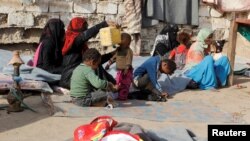 FILE - Internally displaced people sit at a makeshift camp for IDPs in al-Jarahi, south of the Red Sea port city of Houdieda, Yemen, Feb. 22, 2017. 