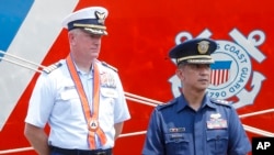 Captain John Driscoll, left, commanding officer of the U.S. Coast Guard National Security Cutter Bertholf (WMSL 750), and Philippine Coast Guard Spokesman Commander Armand Balilo, talk to the media during a port call by the U.S. cutter Wednesday, May 15,