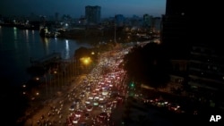 FILE - Traffic moves besides the Saigon river during rush hour in Ho Chi Minh City, Vietnam, Nov. 18, 2015. Senior officials warn air pollution levels in Ho Chi Minh City and Hanoi alone could soon match the deteriorating air quality of Beijing.