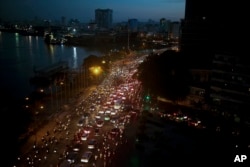 FILE - Traffic moves besides the Saigon river during rush hour in Ho Chi Minh City, Vietnam, Nov. 18, 2015. Senior officials warn air pollution levels in Ho Chi Minh City and Hanoi alone could soon match the deteriorating air quality of Beijing.