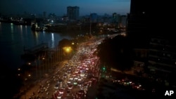 FILE - Traffic moves besides the Saigon river during rush hour in Ho Chi Minh City, Vietnam, Nov. 18, 2015. Senior officials warn air pollution levels in Ho Chi Minh City and Hanoi alone could soon match the deteriorating air quality of Beijing.