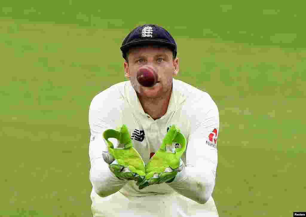 England&#39;s Jos Buttler focuses on the ball as cricket resumes behind closed doors following the outbreak of the coronavirus disease, at Ageas Bowl, Southampton, Britain.