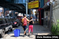 After using heroin, a young white couple struggles to make it down the street.