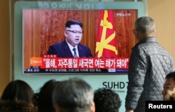 South Koreans watch a TV news program showing North Korean leader Kim Jong Un's New Year's speech, Jan. 1, 2017, at the Seoul Railway Station in Seoul, South Korea.