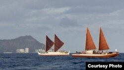 The Hokulea (left) and the Hikianalia sailing off the Hawaiian Islands (date unknown). (Oiwi TV and the Polynesian Voyaging Society)