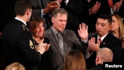 Fred and Cindy Warmbier cry as U.S. President Donald Trump talks about the death of their son Otto after his arrest in North Korea during the State of the Union address to a joint session of the U.S. Congress on Capitol Hill. (Reuters/Jonathan Ernst)