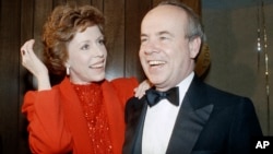 FILE - Carol Burnett, left, and veteran comrade in comedy Tim Conway laugh during a gala birthday party for Burnett in Los Angeles, April 26, 1986.
