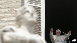 Pope Benedict XVI acknowledges the crowd during a prayer from his studio window overlooking St. Peter's Square at the Vatican, Sunday, May 15, 2011