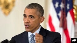 President Barack Obama speaks to reporters in the State Dining Room of the White House in Washington, Oct. 2, 2015.