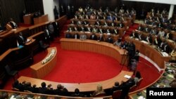 Ivory Coast's President Alassane Ouattara addresses the Ivorian parliament during the presentation of a new constitution project in Abidjan, Oct. 5, 2016. 