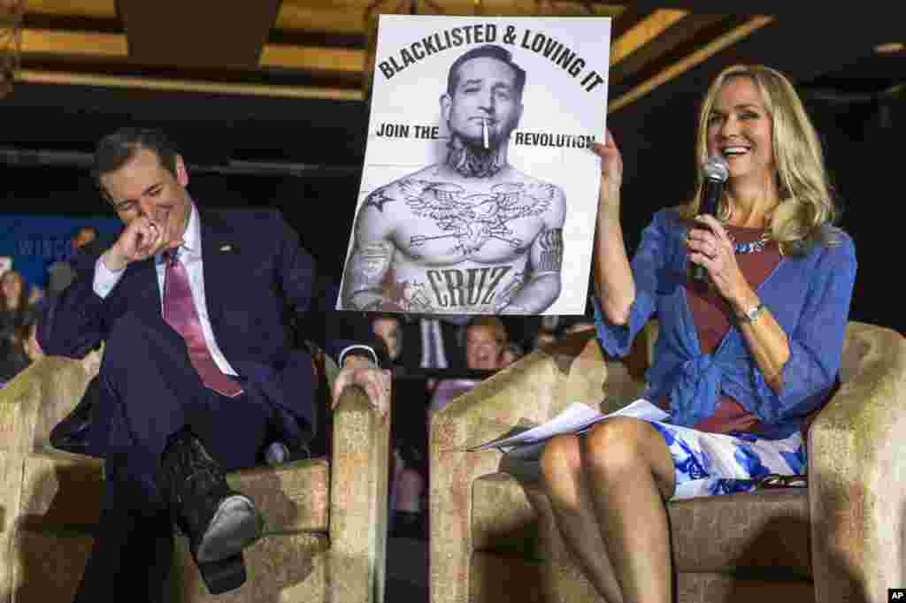 Republican presidential candidate Sen. Ted Cruz, R-Texas reacts to a poster displayed by moderator Rebecca Hagelin during a campaign stop in Madison, Wisconsin.