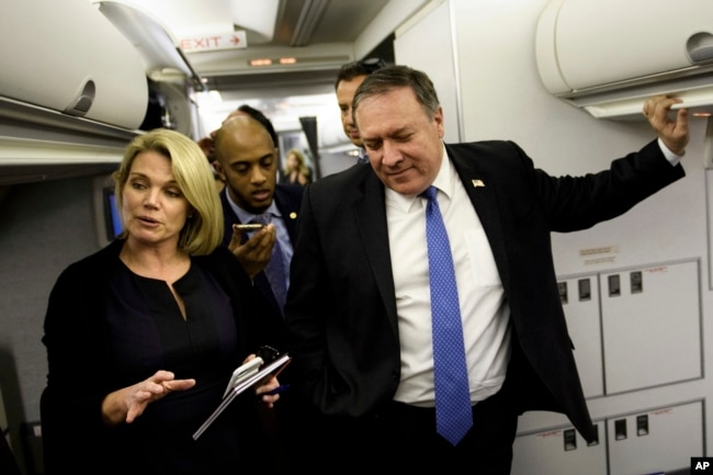 FILE - State Deptartment spokesperson Heather Nauert, left, and Secretary of State Mike Pompeo speak with reporters in his plane while flying from Panama to Mexico, Oct. 18, 2018.