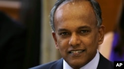 FILE - Singapore's Minister for Foreign Affairs and Law K. Shanmugam poses for photographs before a dinner with U. S. Secretary of State Hillary Rodham Clinton at the Ministry of Foreign Affairs, Nov. 16, 2012.