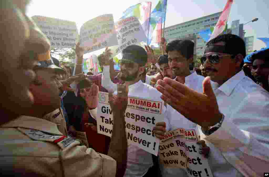 Police stop a group of the students from the National Students Union of India, during a protest outside the U.S. consulate in Mumbai. India&#39;s information minister lashed out at the United States on Friday and demanded an apology for the treatment and arrest of Devyani Khobragade, India&#39;s deputy consul general in New York.