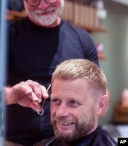 Norway's Minister of Health, Bent Hoie Abid Raja gets his hair cut by hair dresser Morten Johansen, as hair dressers reopened after being closed down for more than six weeks in an effort to avoid spreading fo the COVID-19 Coronavirus, in Oslo, Norway.