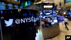 An updated phone post on the floor of the New York Stock Exchange features a Twitter logo, Nov. 4, 2013, in New York. 