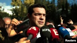 Alexis Tsipras, opposition leader and head of radical leftist Syriza party, talks to reporters outside the parliament building after the last round of a presidential vote in Athens, December 29, 2014.