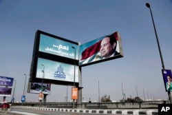 An election campaign banner for Egyptian President Abdel Fattah el-Sissi, with Arabic that reads, "Yes ... to build the future," hangs over a bridge in Cairo, March 14, 2018.